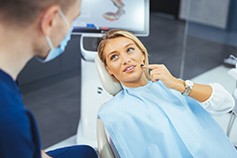 Woman talking to dentist during check-in visit